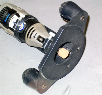 A garnite bit will make a cleaner hole than a router bit or sanding drum.