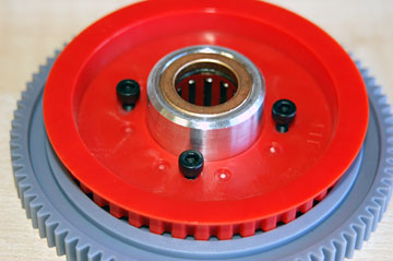 Apply loctite and thread the four screws holding the one way clutch housing to the gears.