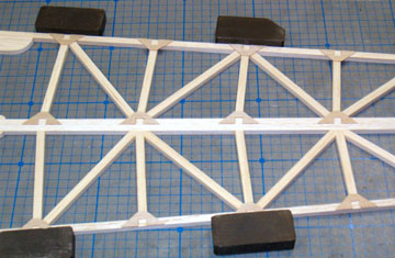 Flip the fuselage sides around, align them and glue the gussets in place.