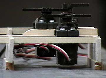 The servo rail supports are located so that the bottoms of the servos do not contact the fuselage.