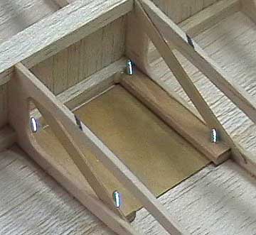 Hatch mounts are reinforced with trusses.  The hatches are held in place with small wood or sheet metal screws.