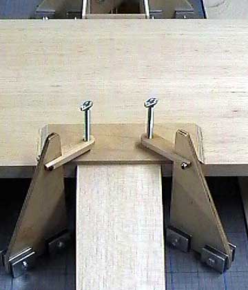 Vertical presses apply clamping pressure.