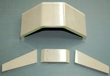 The form and clamp blocks are covered with plastic drop cloth material.