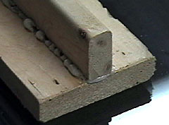 A pushblock is used to grip the balsa sheet and move it back and forth against the fixture.