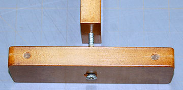 The post is held to the base by a single wood screw.