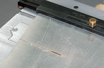 A silicon oxide cutting wheel in my table saw cuts aluminum easily and quickly.