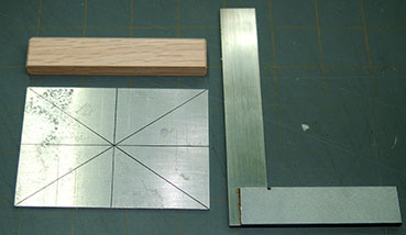 Draw centerlines on both faces of the aluminum plate.