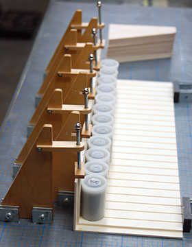 The bottom is clamped in place using vertical presses in magnetic fixtures.